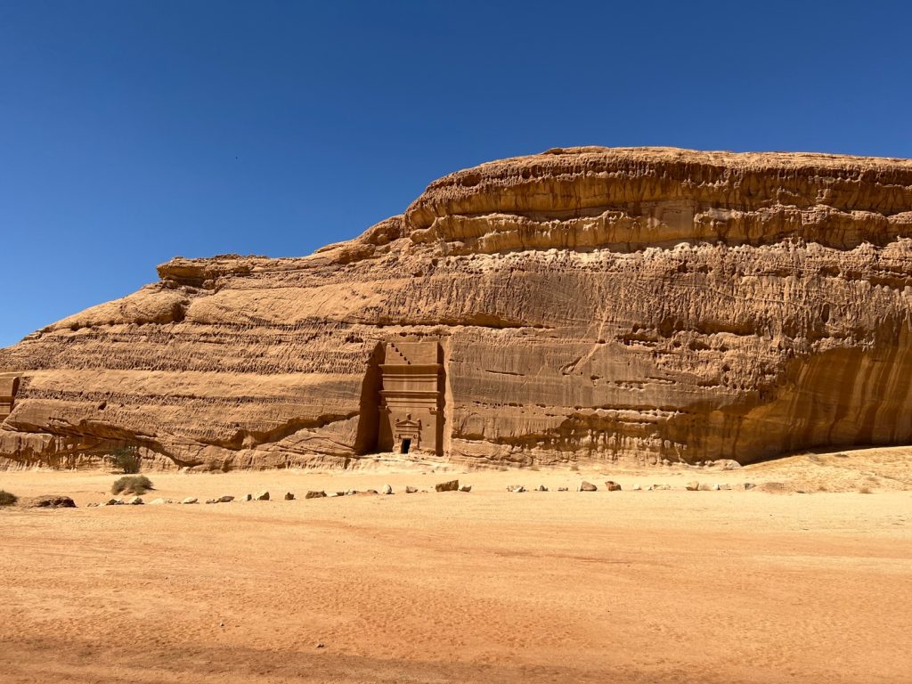 large tomb carved into a rock cliff