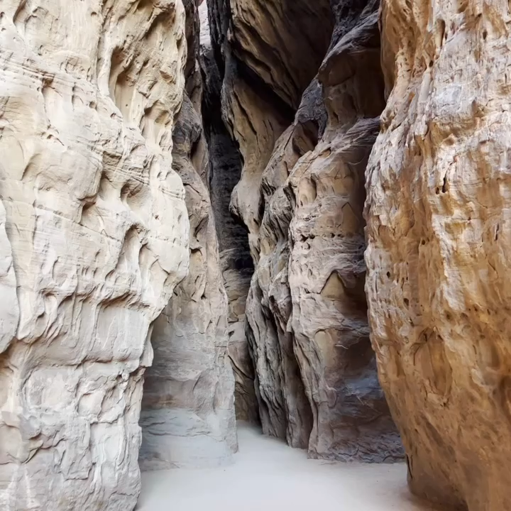 A narrow path through rock cliffs.