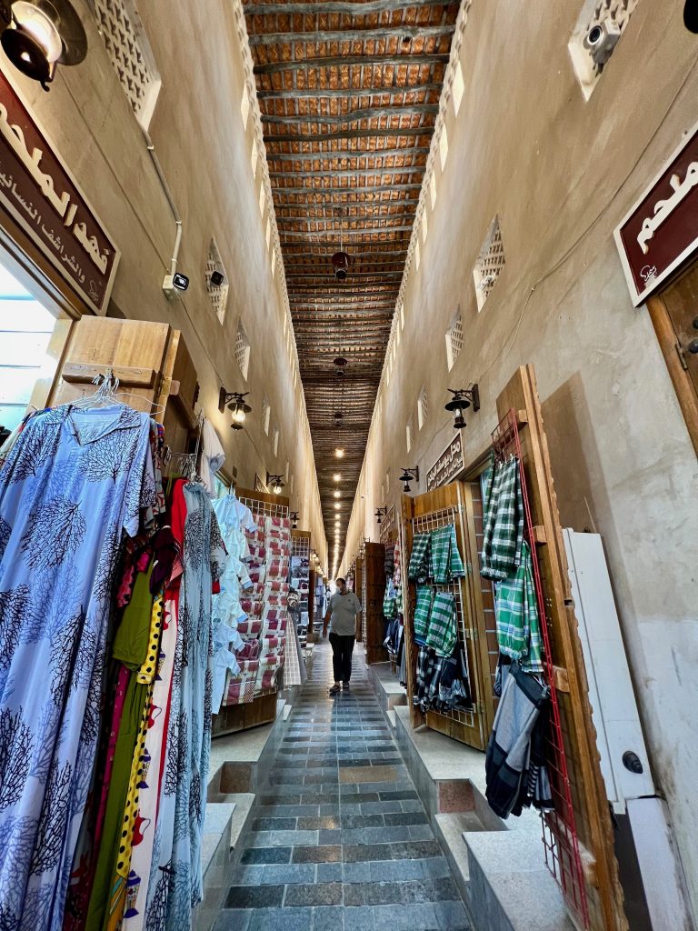 various cloth goods line walls in the corridor of a market