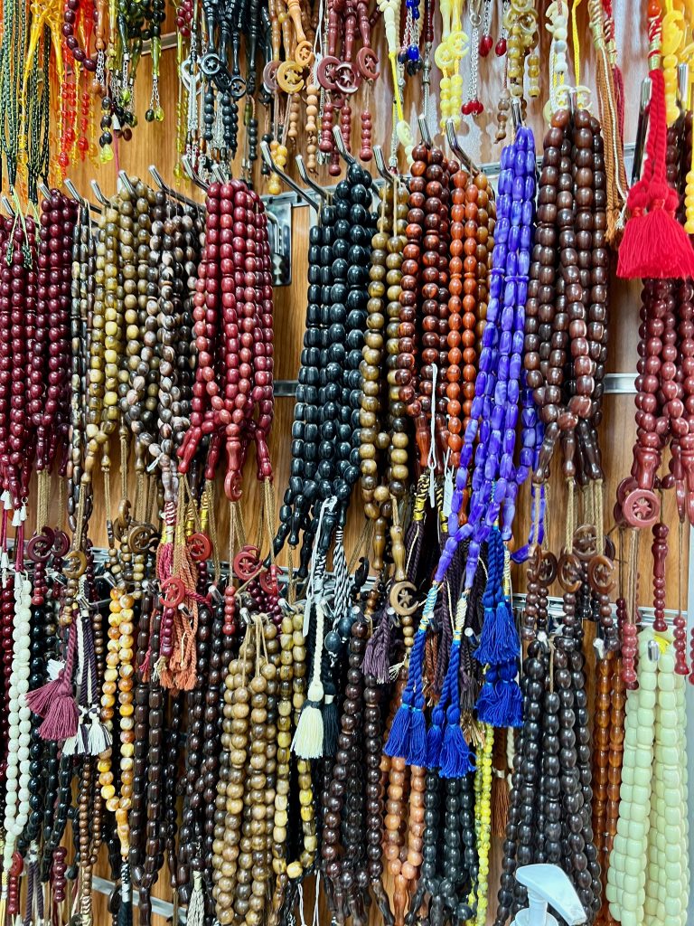 multi-colored beaded chains hanging on a store wall