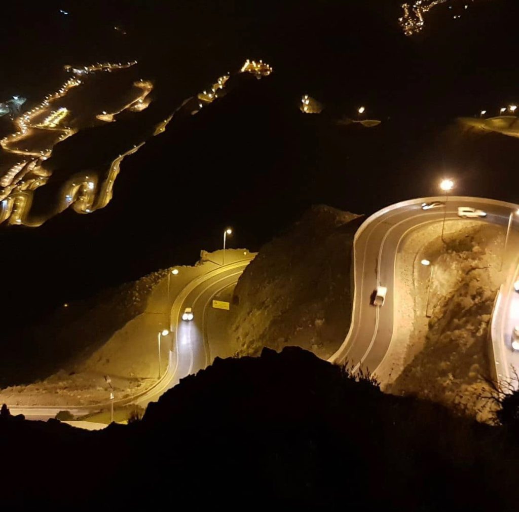 winding mountain roads illuminated at night