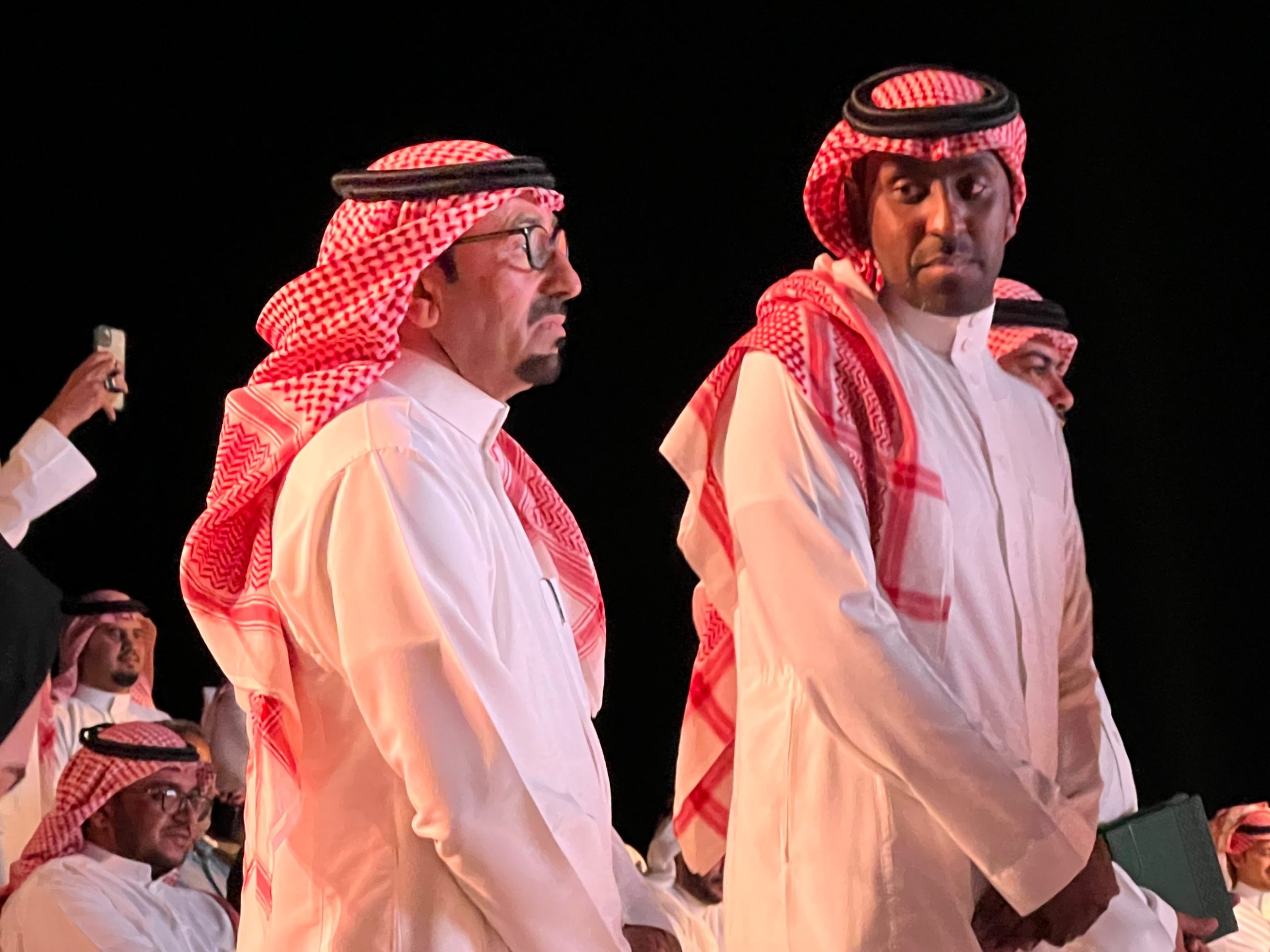 two men in white thobes standing