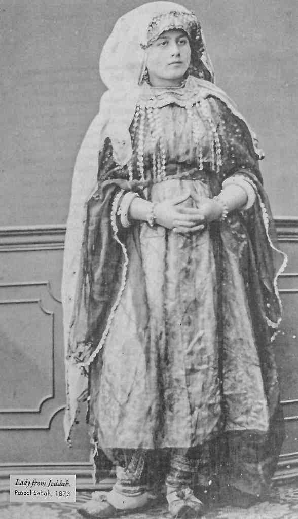 a woman poses for a portrait in ornamental dress