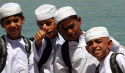 Potential Omani leaders of tomorrow - schoolboys, their book bags strapped to their backs, returning home from a day's study in Qumzar, a small seaside village tucked into a cove adjacent to the Hormuz Strait.