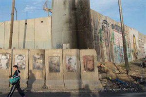 A Palestinian child walks along the separation barrier near the Qalandia checkpoint, which is the primary checkpoint between the northern West Bank and Jerusalem.