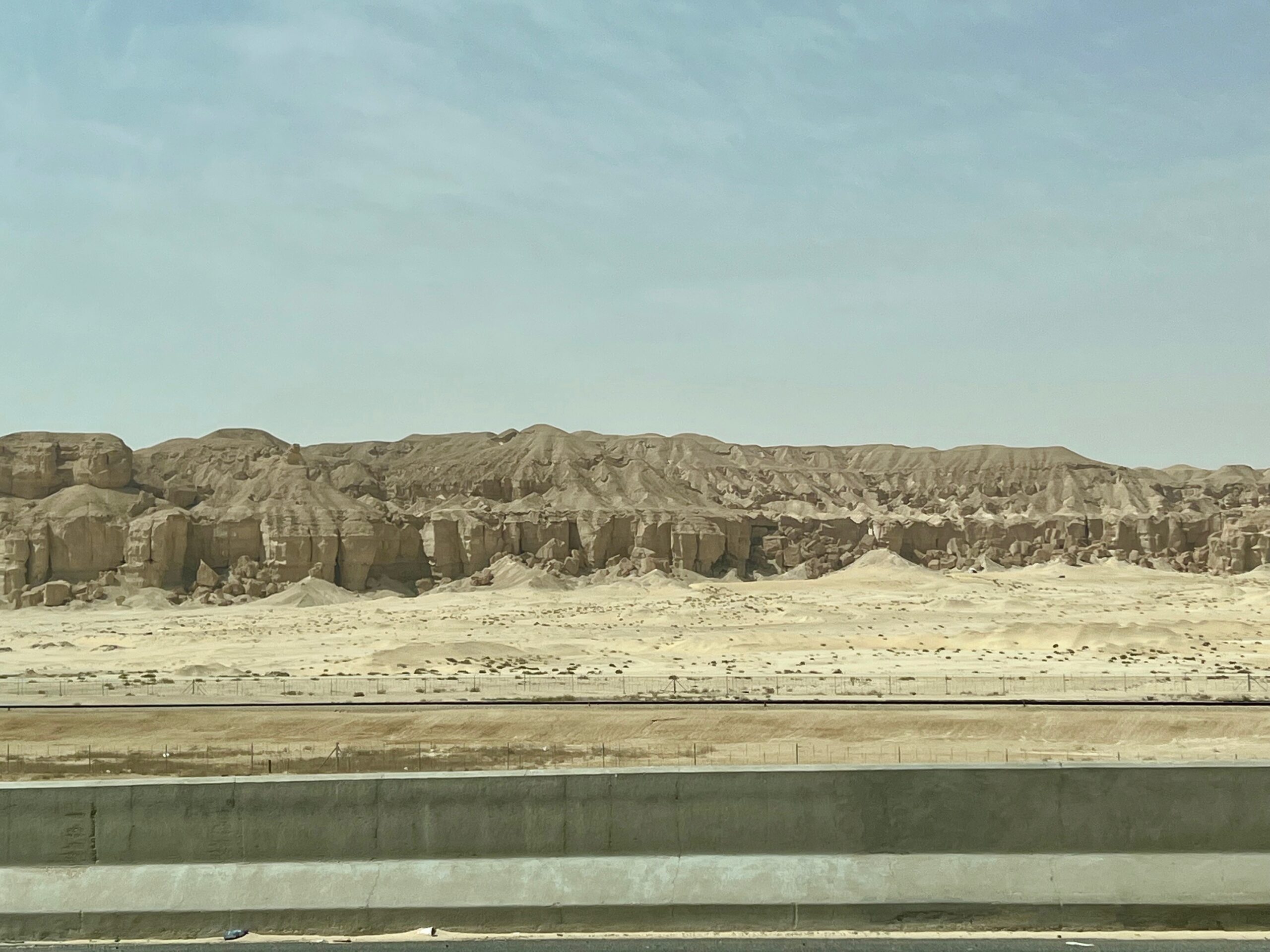 limestone cliffs on the roadside seen through a car window