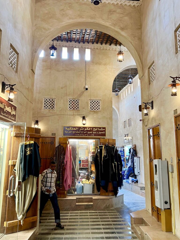 a shop in a market with bishts on display