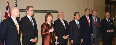 P5+1 foreign ministers, along with Iranian Foreign Minister Javad Zarif (center), listen as European Union High Representative Catherine Ashton speaks after the group concluded negotiations about Iran's nuclear capabilities on November 24, 2013. Photo: U.S. Department of State. 