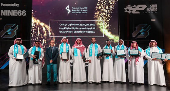 a group of men in thobes displaying diplomas